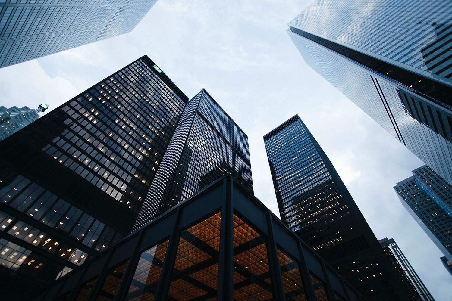 Skyscrapers in a modern business district, reflecting cityscape and highway.